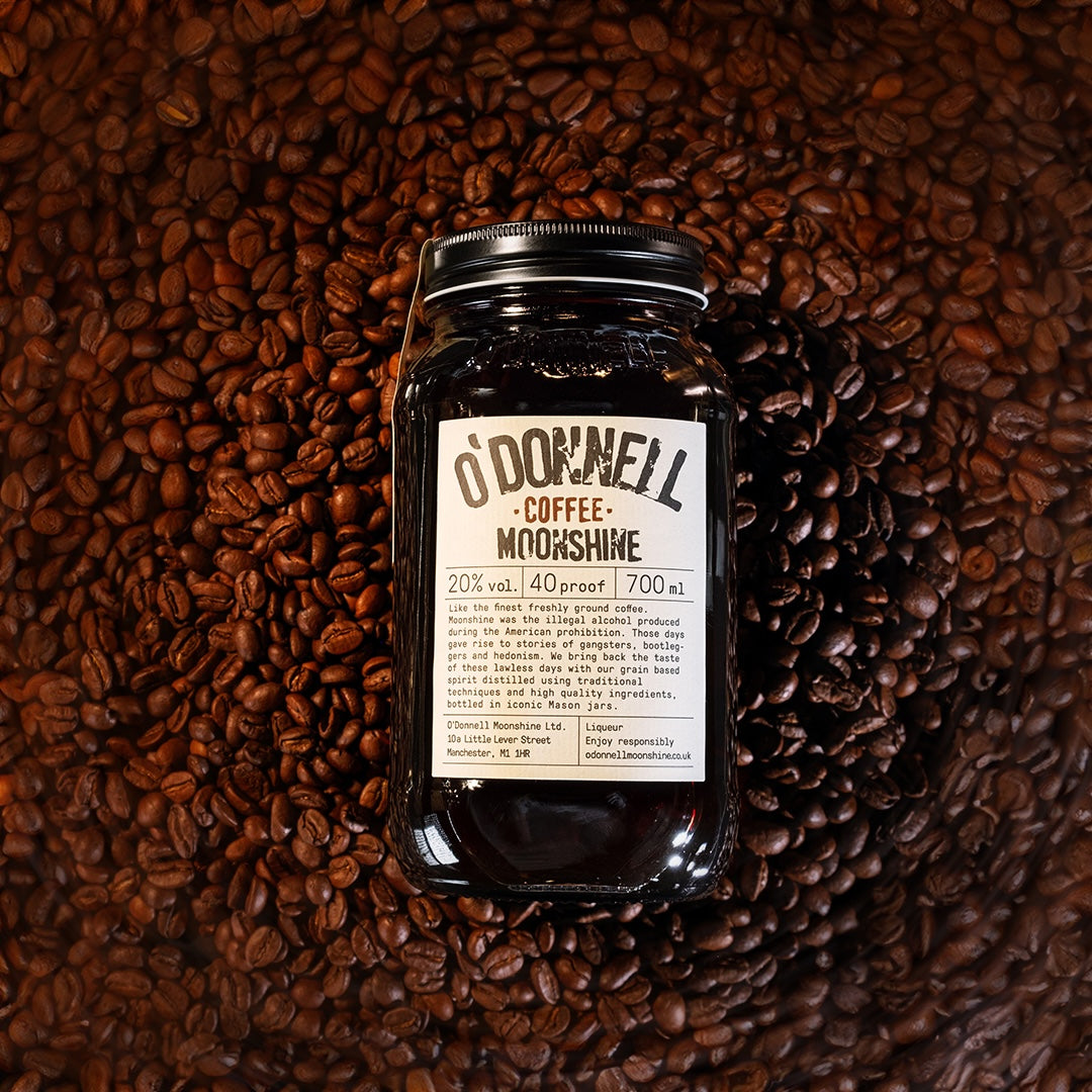 Coffee Moonshine laying on coffee beans