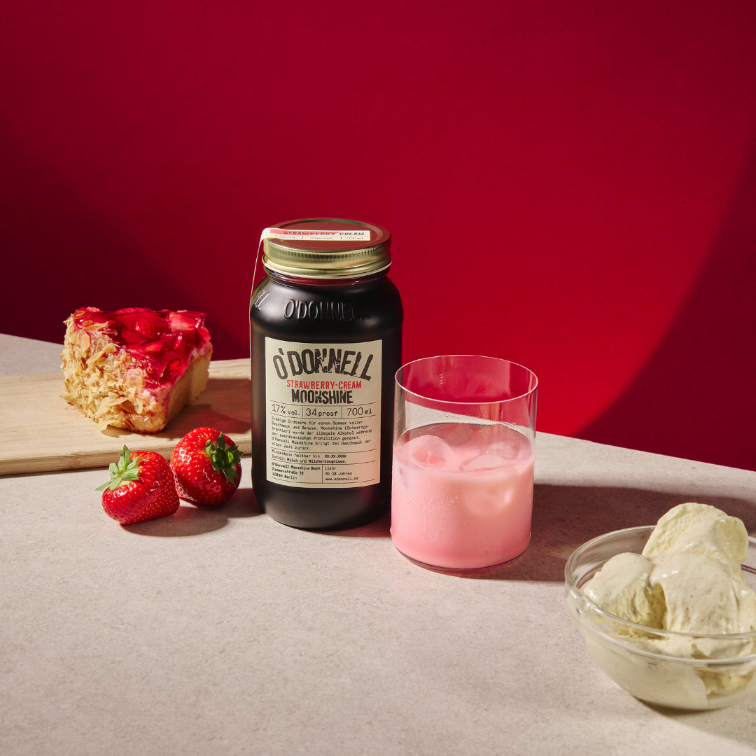 Strawberries & Cream next a glass half full with red background