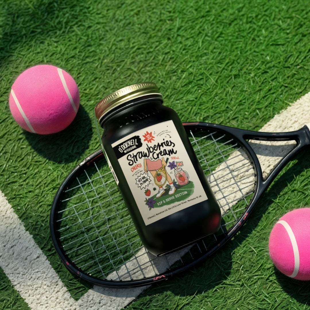 Strawberries & Cream Wimbledon edition on grass with racket and tennis balls