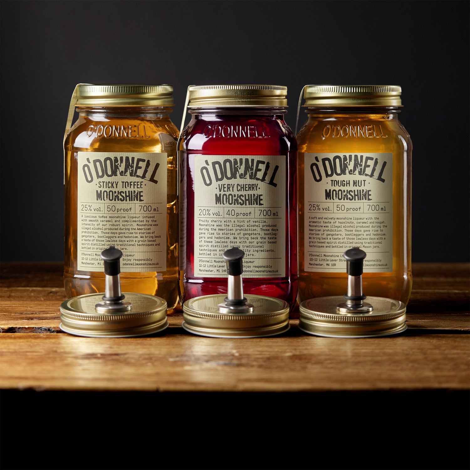 Set of 3 Moonshines, sticky toffee, very cherry and tough nut moonshine are shown with pouring lids