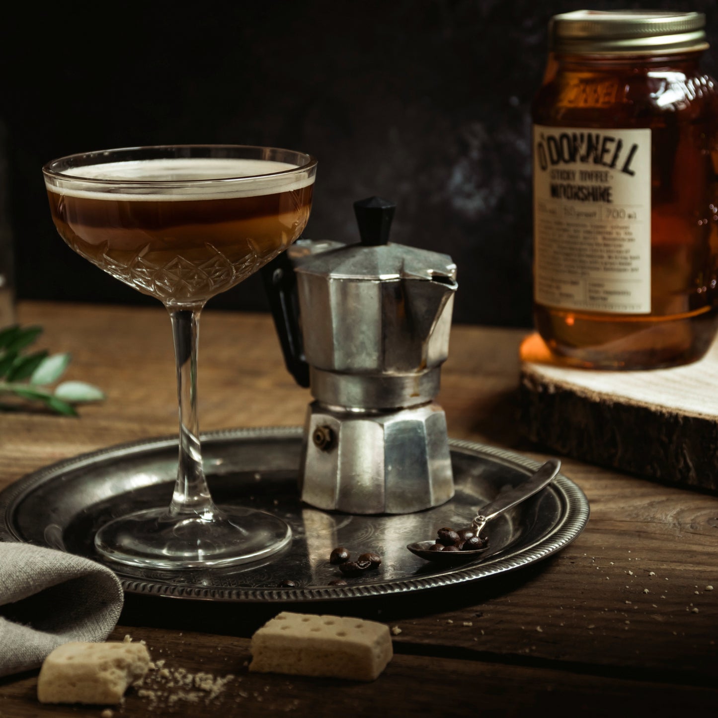 sticky toffee long drink cocktail next to coffee pot