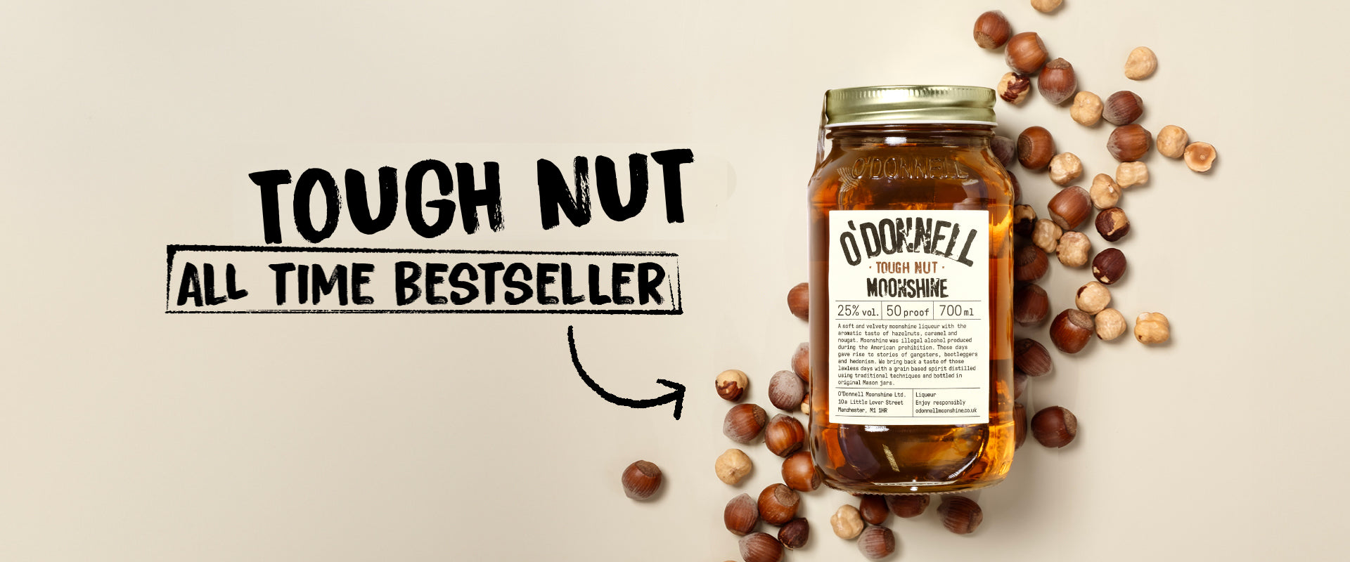 Jar of O'Donnell Moonshine Tough Nut on a cream background surround by hazelnuts