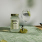 700ml Jar Lime Moonshine next to a Spritz glass and pouring lid