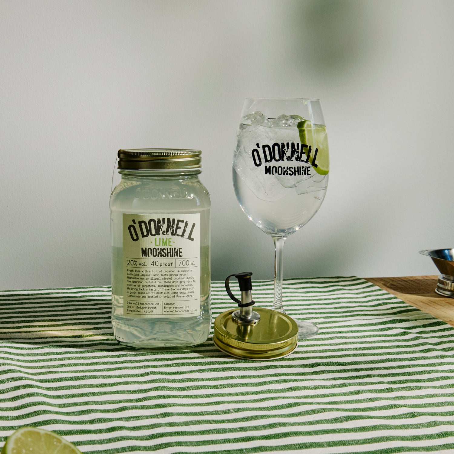700ml Jar Lime Moonshine next to a Spritz glass and pouring lid