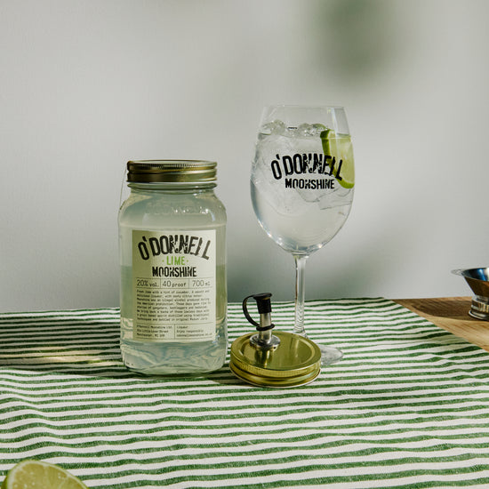 700ml Jar Lime Moonshine next to a Spritz glass and pouring lid