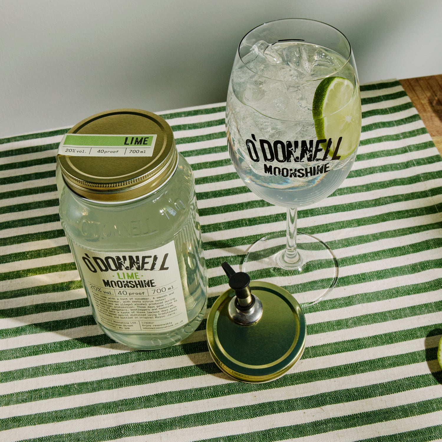 700ml Jar Lime Moonshine next to a Spritz glass and pouring lid