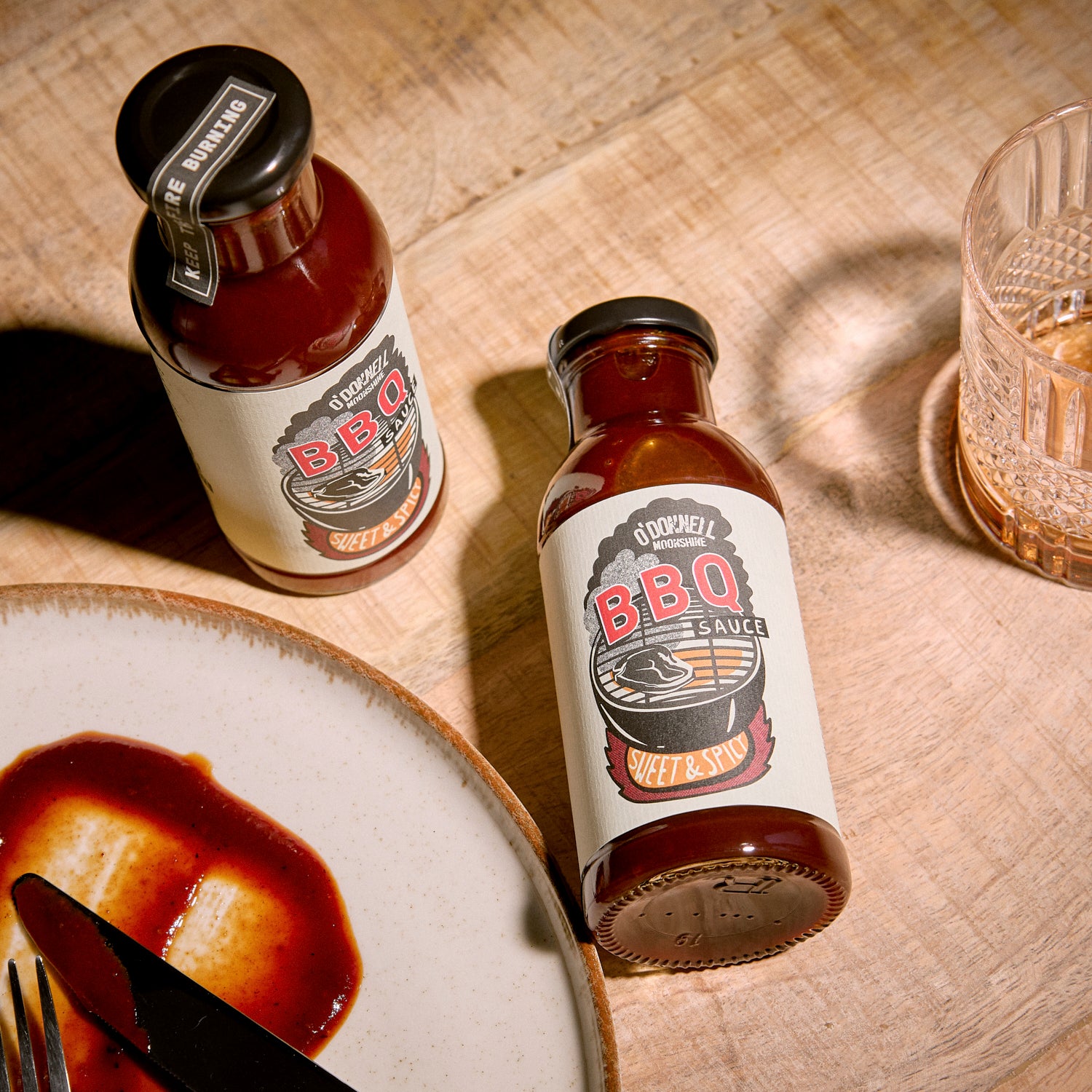 Two Bottle of Sweet & Spicy BBQ sauce on a wooden table