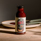 Bottle of Sweet & Spicy BBQ sauce on a wooden table
