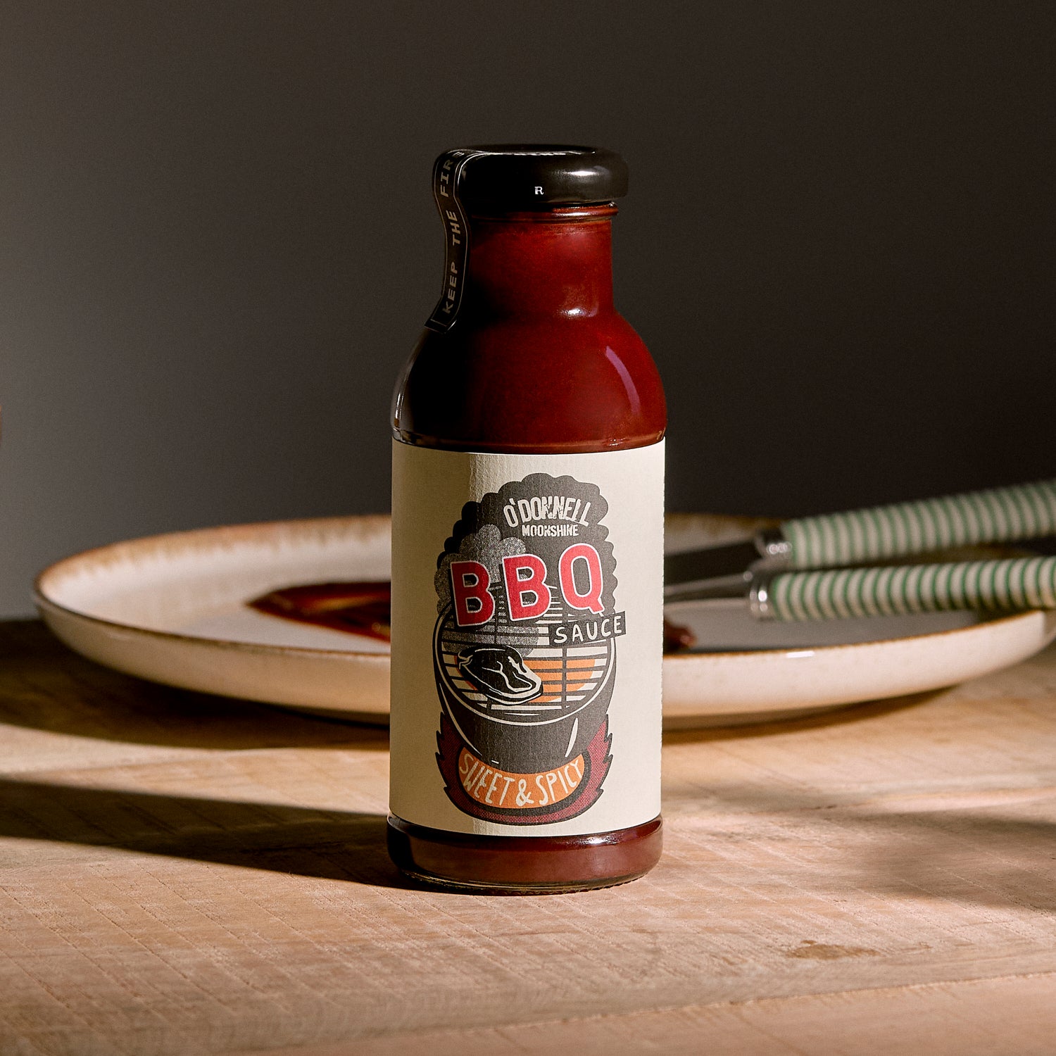 Bottle of Sweet & Spicy BBQ sauce on a wooden table