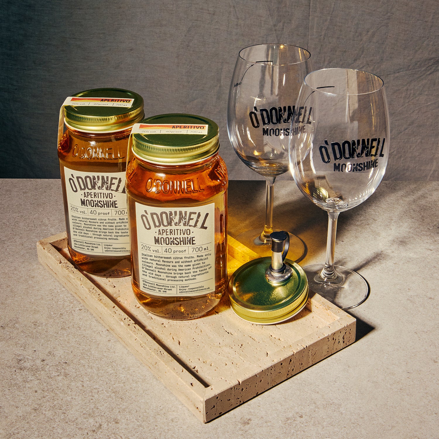 Two O'Donnell Sprit Glasses next to 2 700ml Jars of Aperitivo Moonshine and a pouring lid