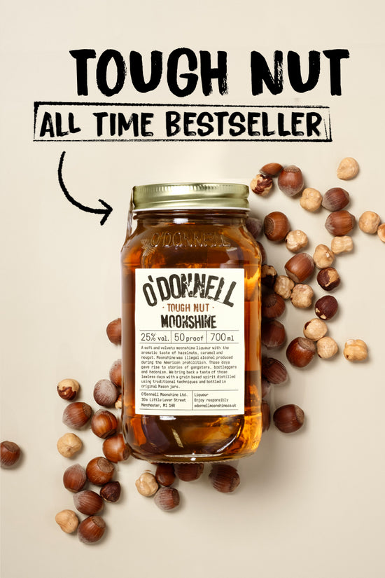 Jar of O'Donnell Moonshine Tough Nut on a cream background surround by hazelnuts