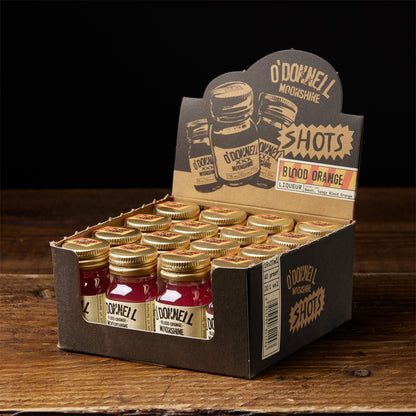 A box of O'Donnell Micro Moonshine shots displayed on a wooden surface - flavour blood orange
