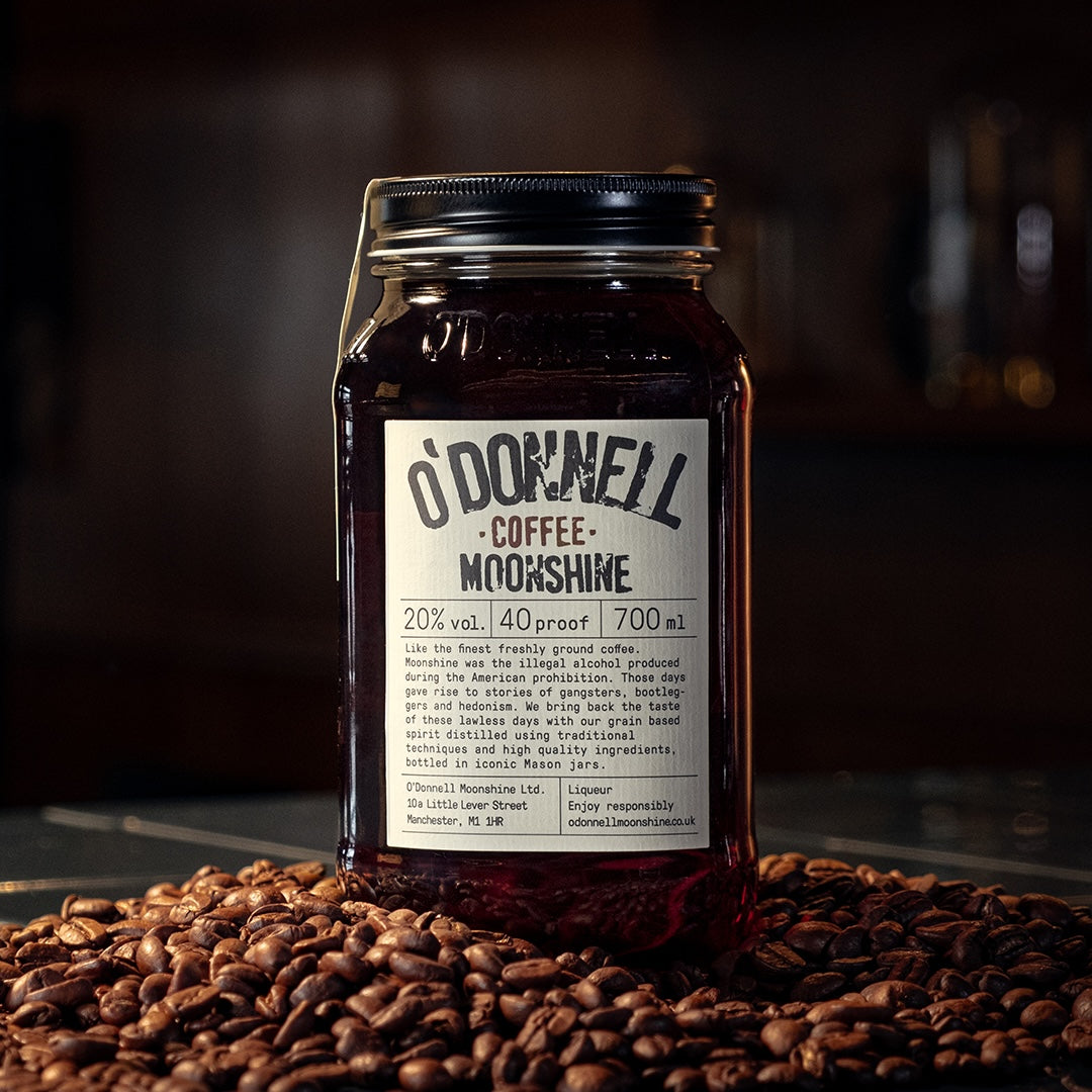 O'Donnell Coffee on a table with coffee beans