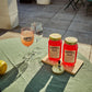 Two O'Donnell Sprit Glasses next to 2 700ml Jars of Blood Orange Moonshine and a pouring lid