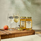 Two O'Donnell Sprit Glasses next to 2 700ml Jars of Peach Moonshine and a pouring lid