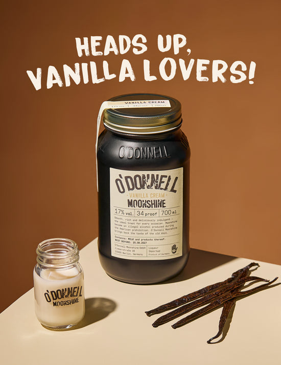 O'donnell vanilla cream moonshine jar against a brown background with a shot of moonshine and a vanilla pods with the text, Heads up vanilla lovers!