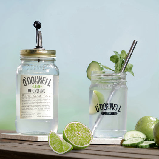 Lime moonshine with pouring lid, glass and metal straw