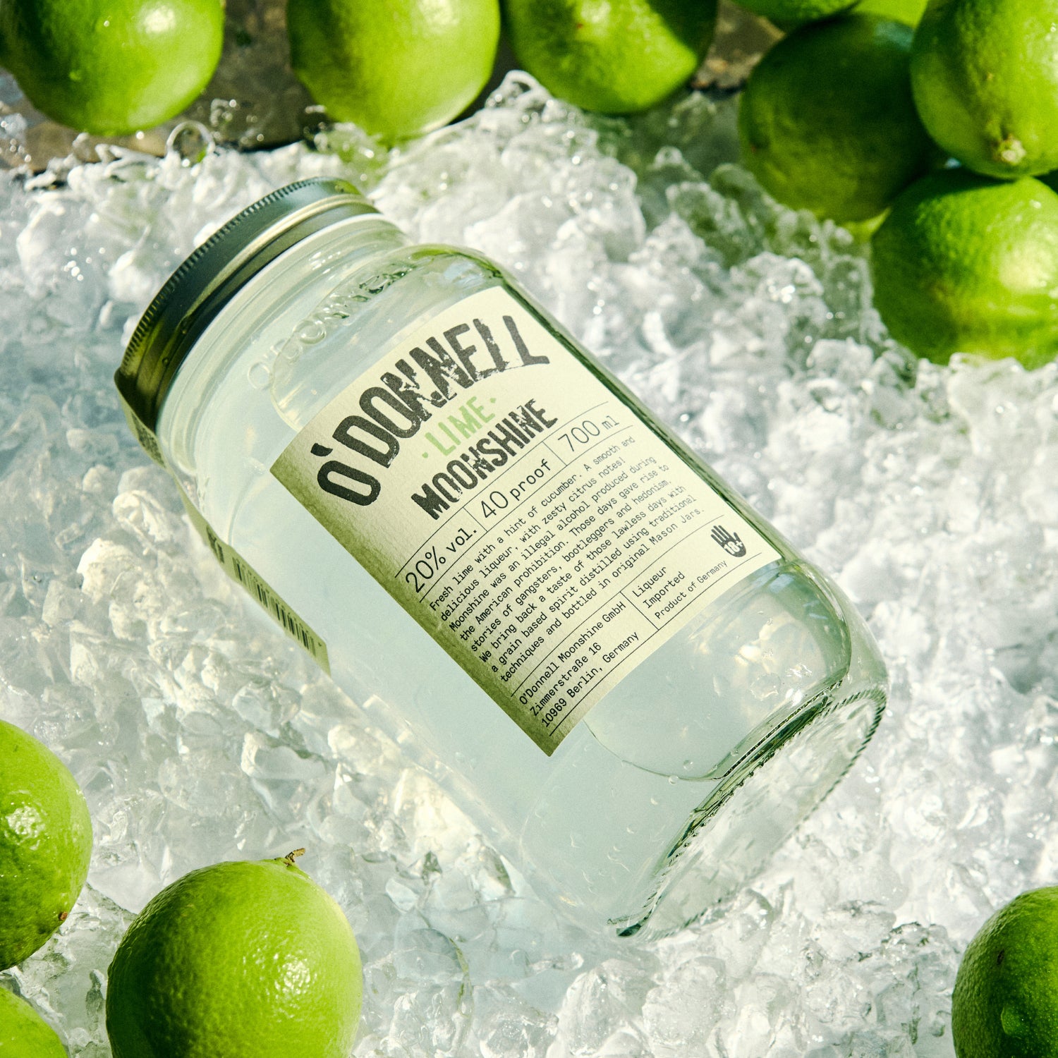 Jar of O'Donnell Moonshine on ice with limes 