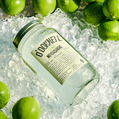 Jar of O'Donnell Moonshine on ice with limes 