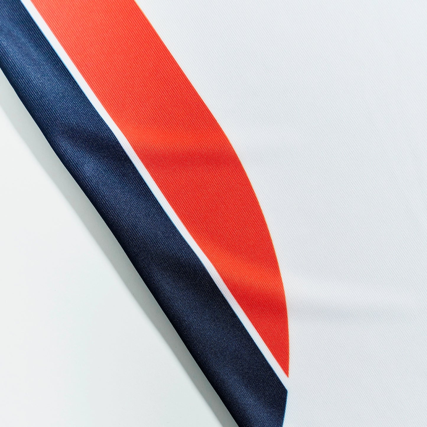 O'Donnell Moonshine WM Football Jersey – close-up of navy and orange side stripe detail on white jersey fabric