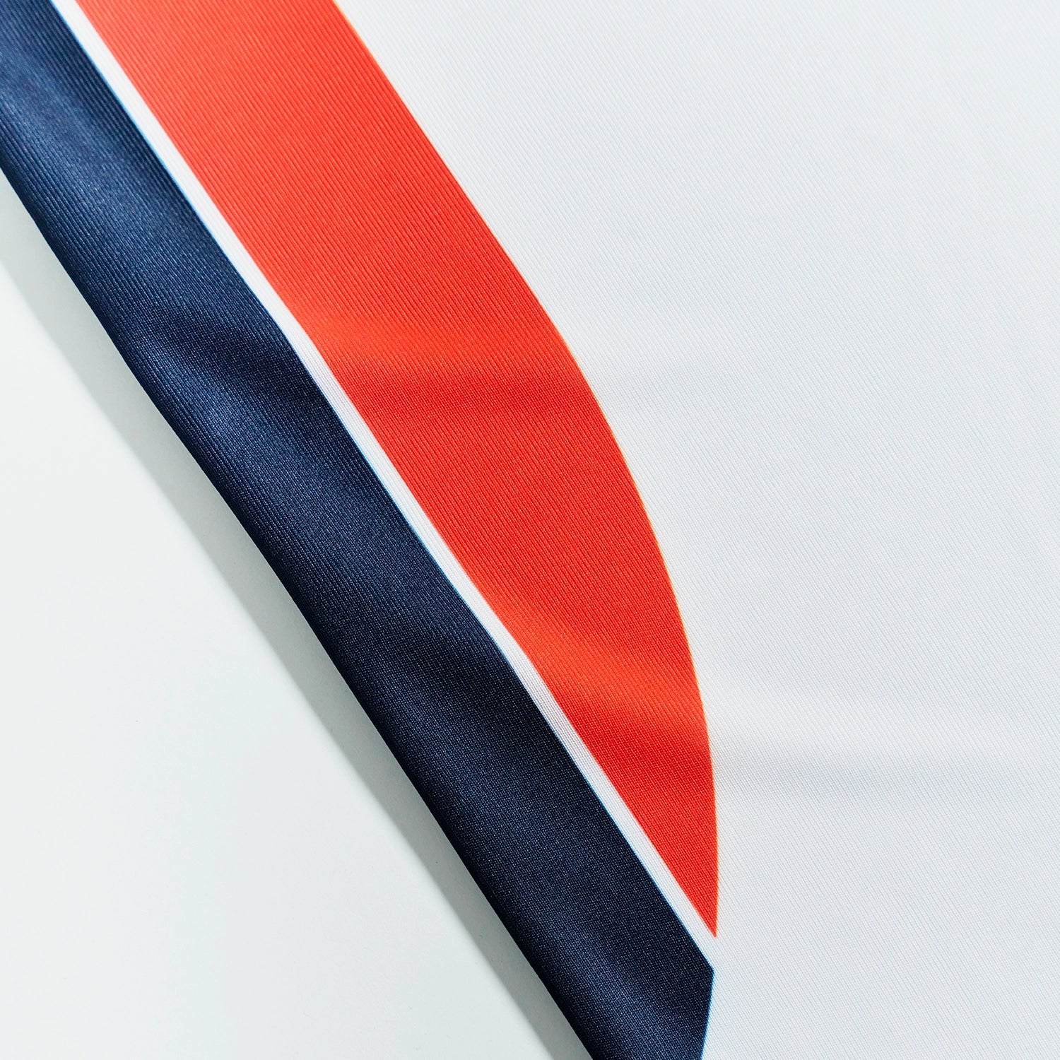 O'Donnell Moonshine WM Football Jersey – close-up of navy and orange side stripe detail on white jersey fabric