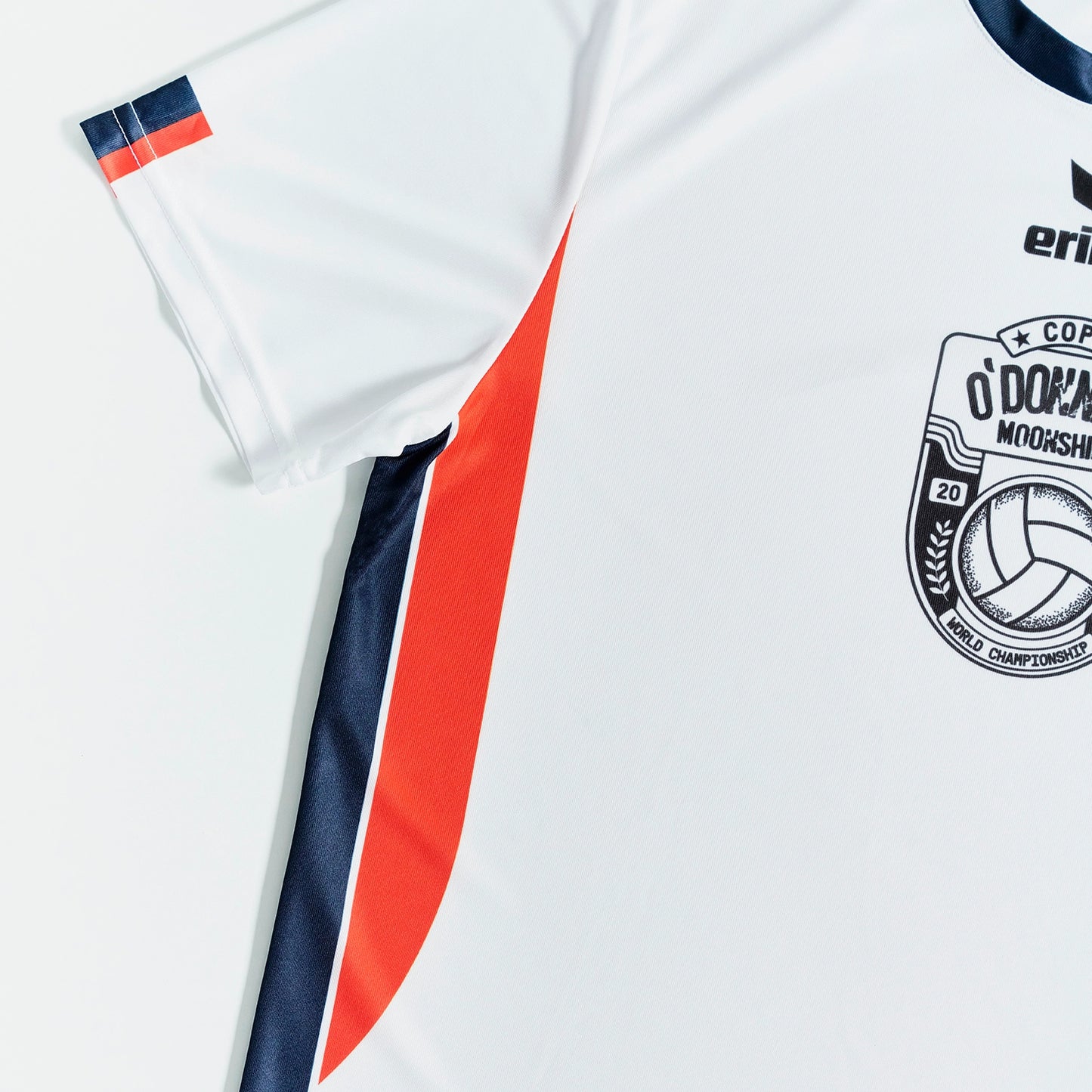 O'Donnell Moonshine WM Football Jersey – angled side view showing orange side stripe and navy trim, Copa badge visible, white background