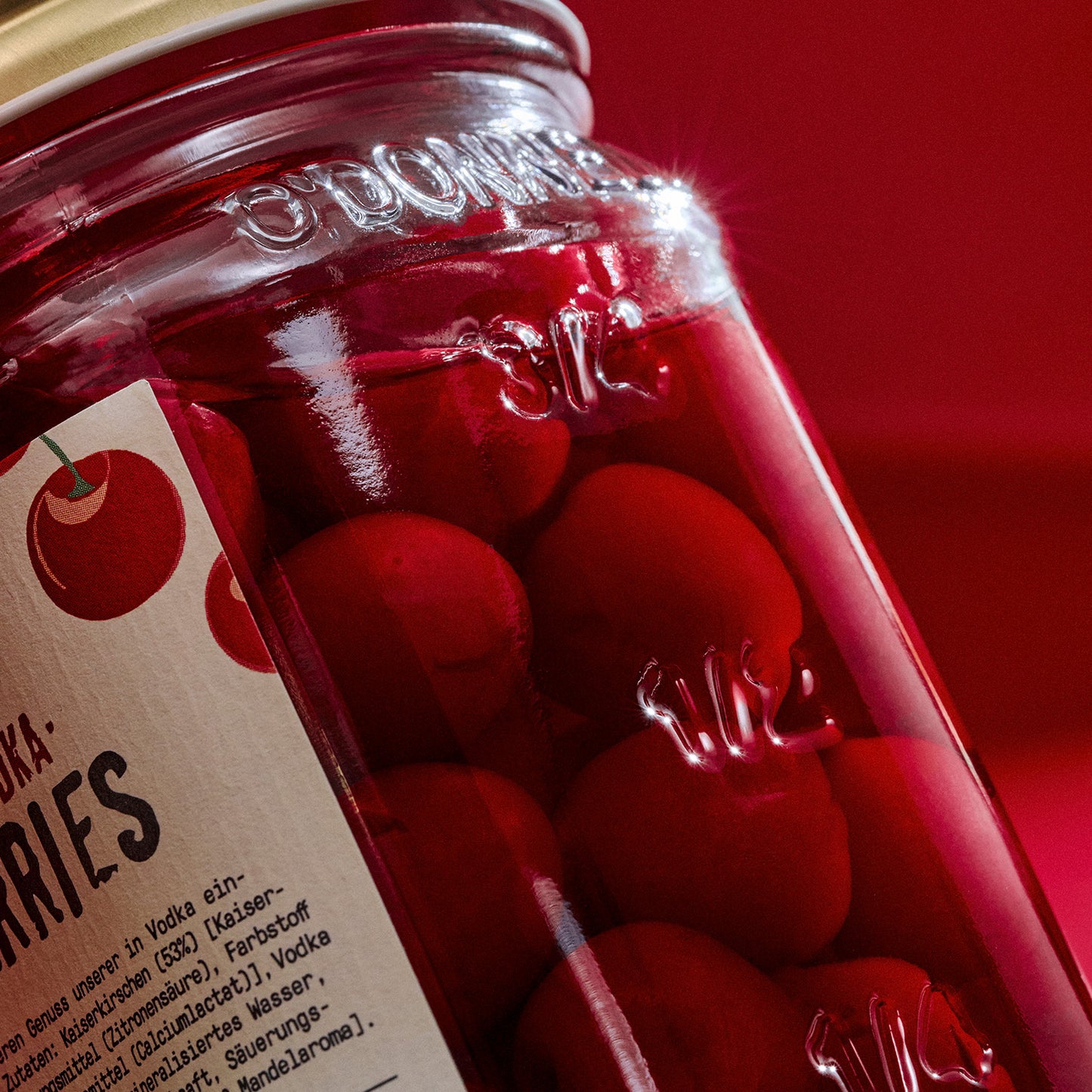 Jar of O'Donnell Very Vodka Cherries on a red background