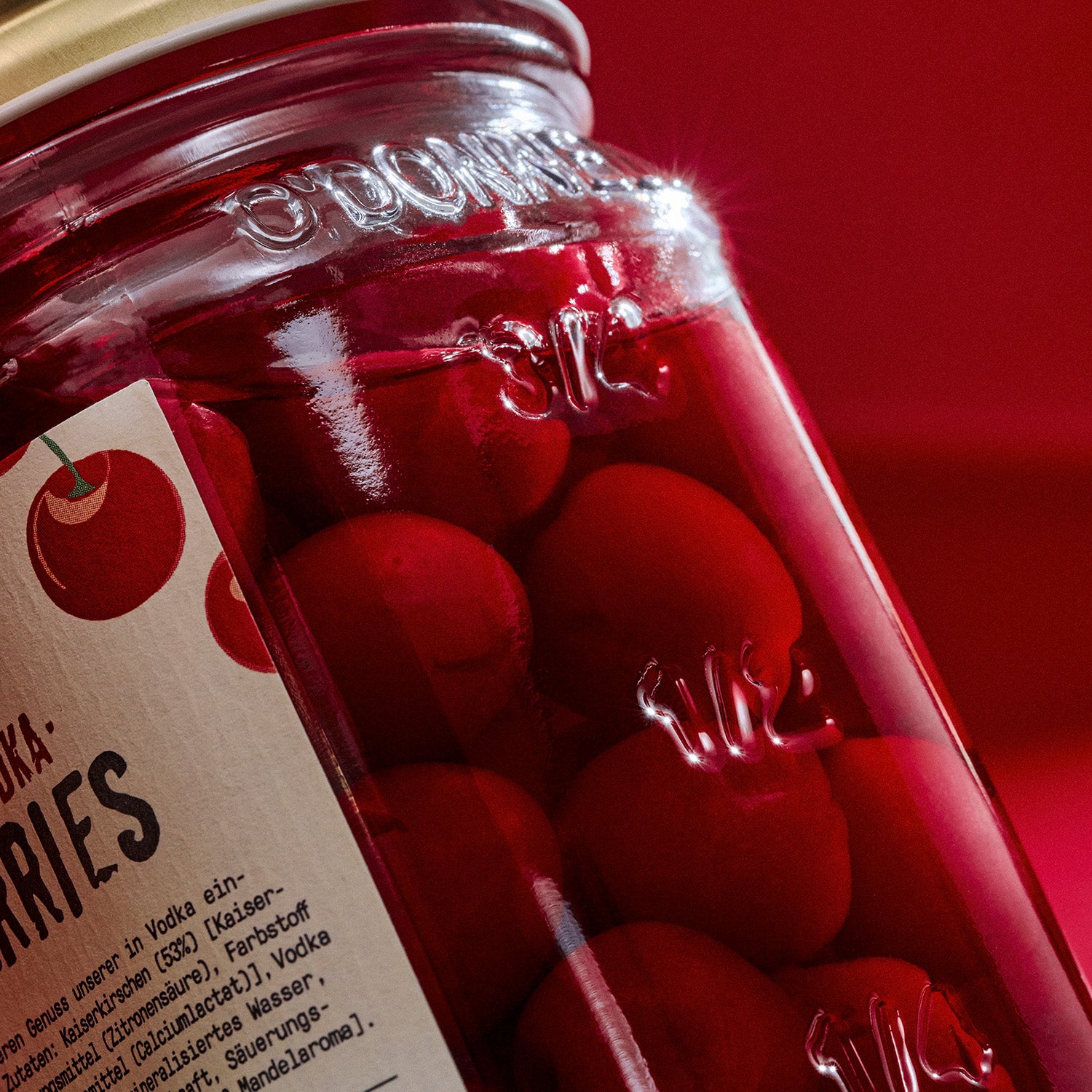 Jar of O'Donnell Very Vodka Cherries on a red background