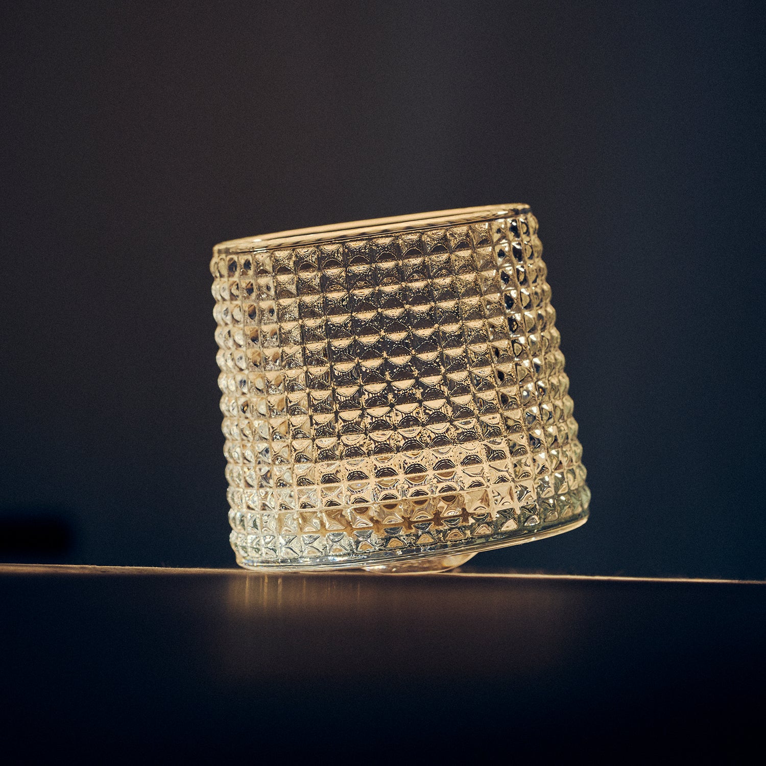 Textured Tumbler Glass on a dark background
