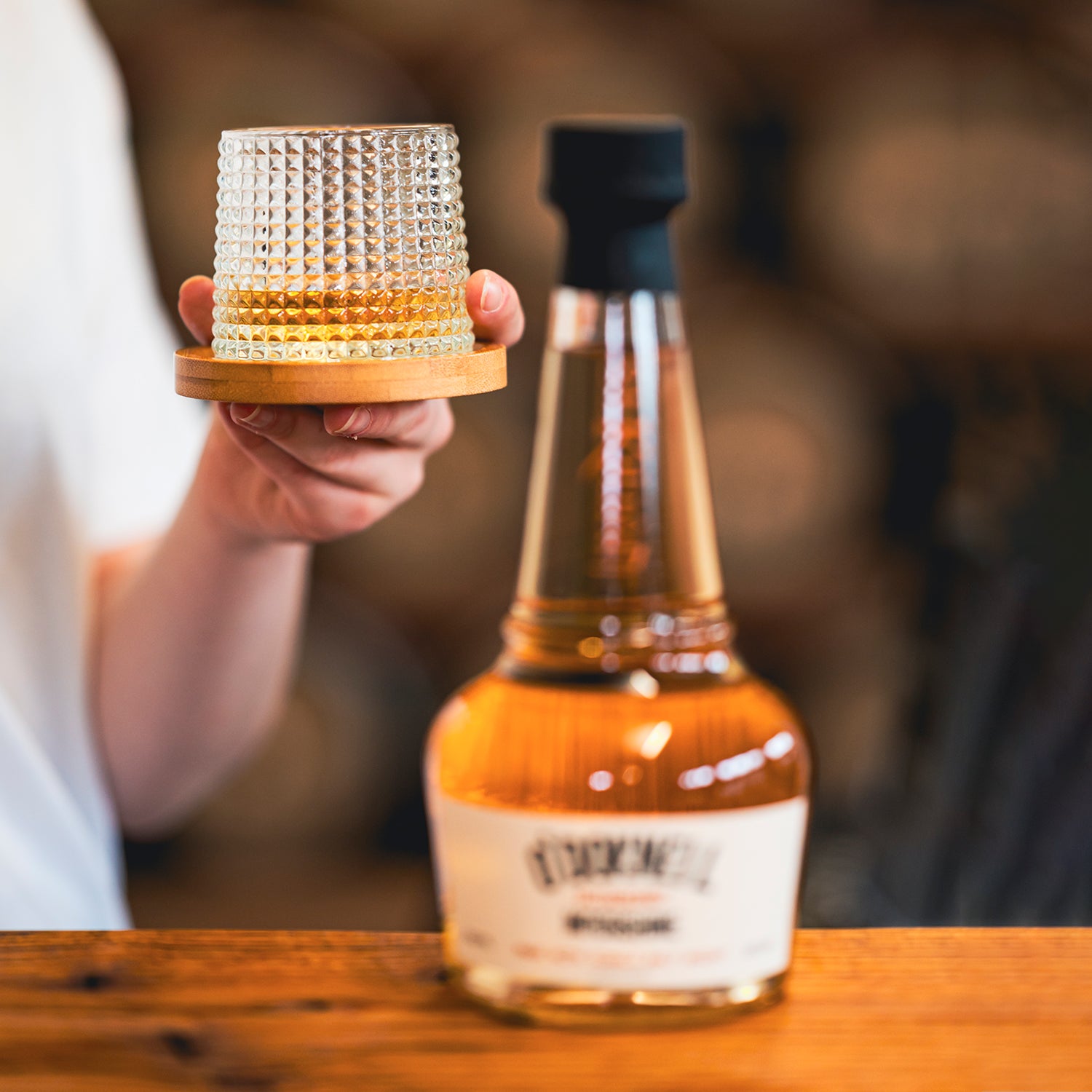 bottle of blueberry moonshine whisky on a wooden surface