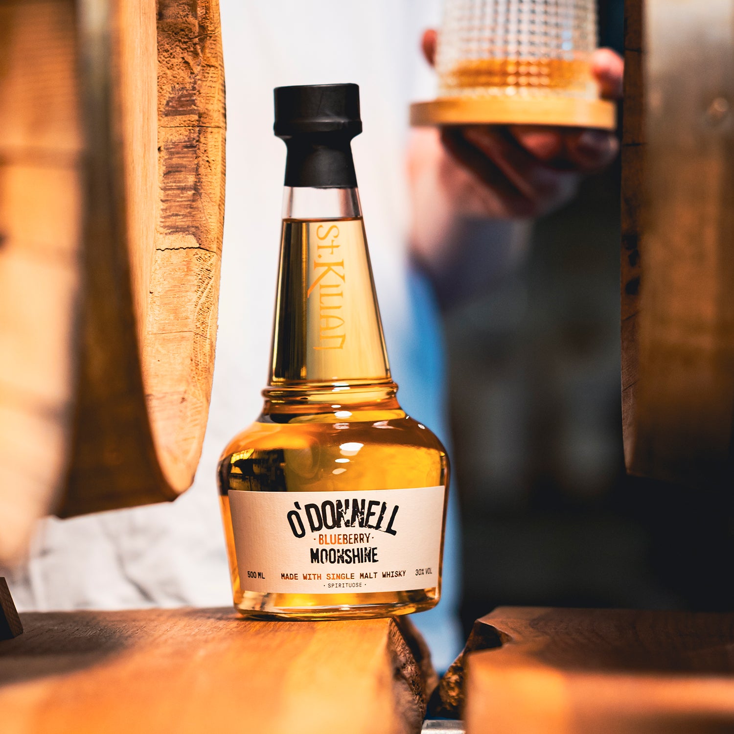 Bottle of O'Donnell Blueberry Moonshine on a wooden surface with a blurred background