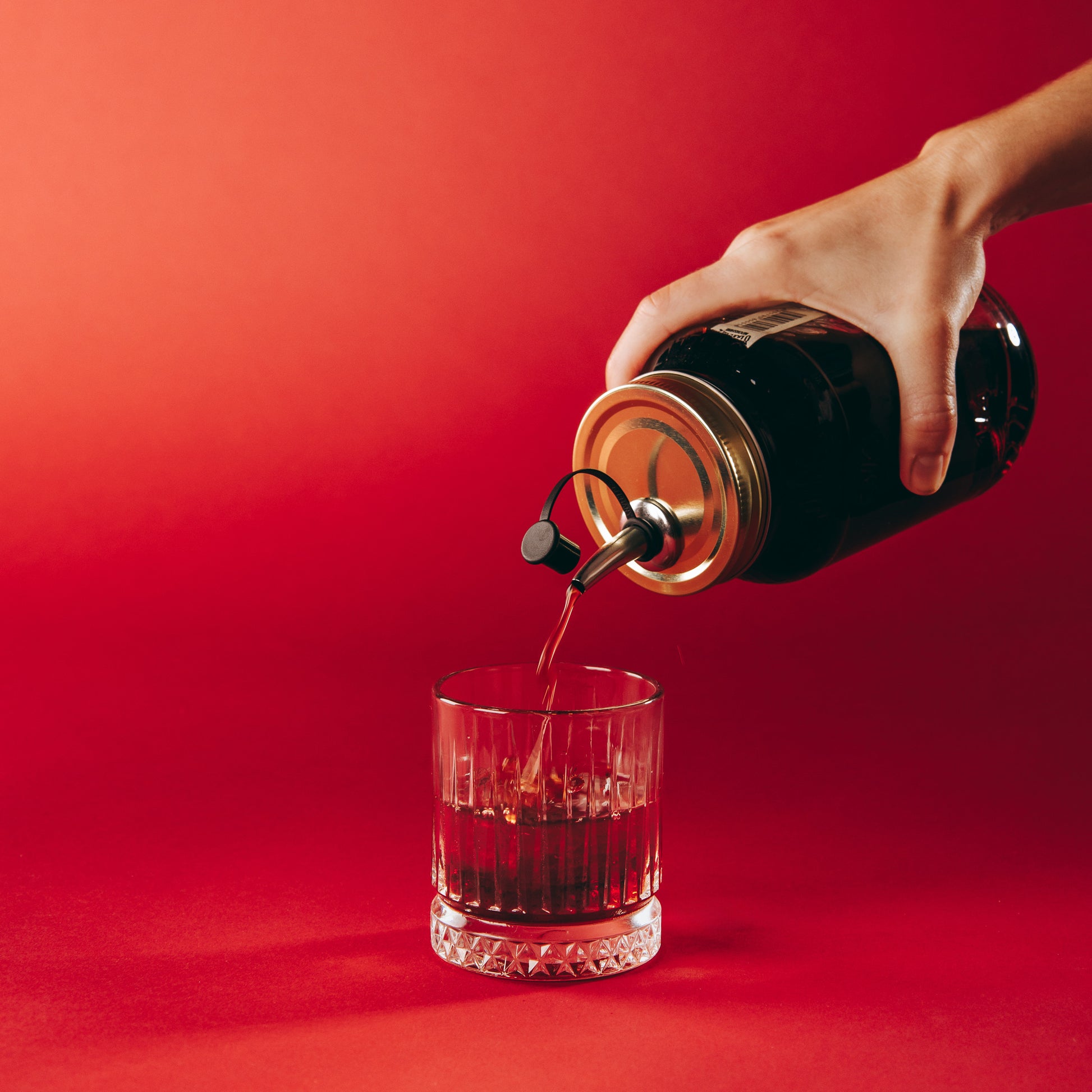 Strawberry Rhubarb being pour via a pouring lid into a glass