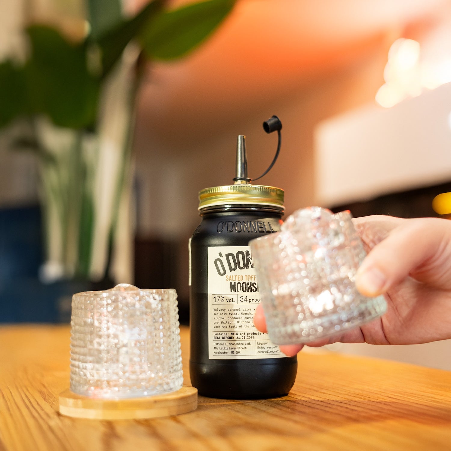 Salted Toffee Cream 700ml Jar on a table with 2 tumblers of ice on the table alongside