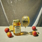 A Peach moonshine 700l Jar next to a O'Donnell Moonshine Spritz glass 