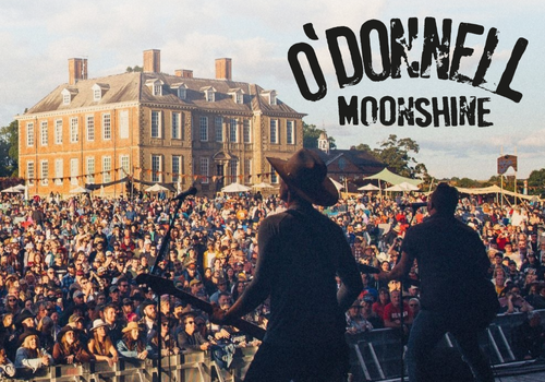 Large outdoor event with a crowd and stage, featuring O'Donnell Moonshine branding.