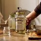 O'Donnell Moonshine elderflower liqueur, with a Mason jar in front of a prepared cocktail.