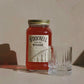 Tough Nut moonshine being poured from a 700ml jar into a small tumbler glass
